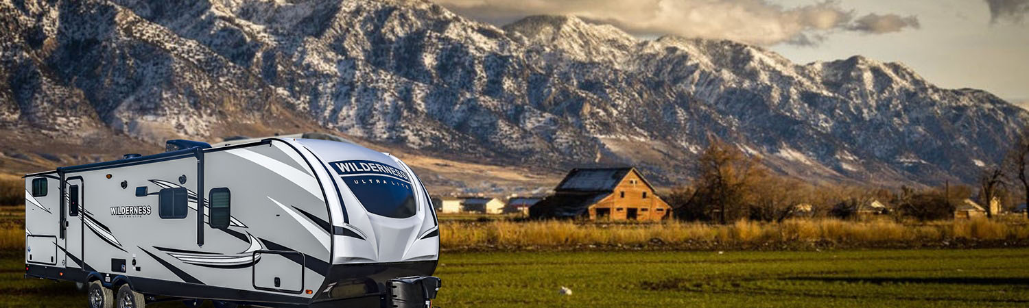 2017 Heartland Elkridge parked in front of a scenic mountain and farm